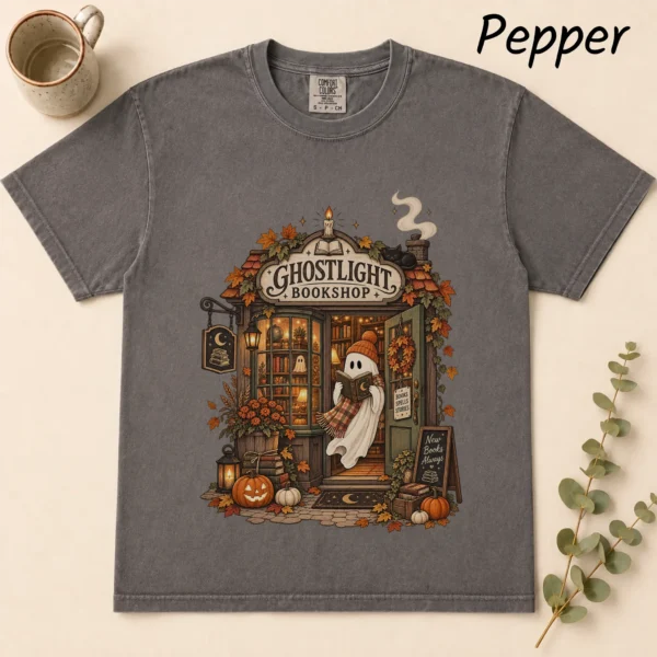 Ghostlight Bookshop Ghost, Spooky Autumn Book Lover — alternate product mockup Ghostlight Bookshop Halloween Shirt t-shirt flat lay view