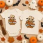 sack mask baby bodysuit flat lay view